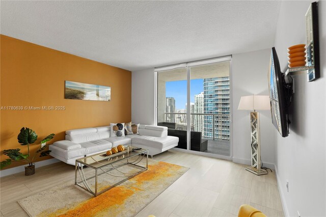 1200 Brickell Bay Dr Ph 4218, Miami, FL 33131 - living area with a wall of windows, a textured ceiling, and baseboards