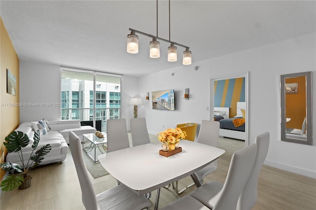 1200 Brickell Bay Dr Ph 4218, Miami, FL 33131 - dining space featuring a textured ceiling and wood finished floors