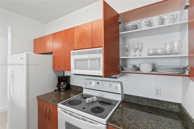 1200 Brickell Bay Dr Ph 4218, Miami, FL 33131 - kitchen with white appliances, open shelves, brown cabinets, and dark stone counters