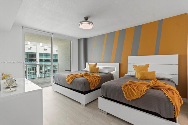 1200 Brickell Bay Dr Ph 4218, Miami, FL 33131 - bedroom featuring access to outside, expansive windows, wallpapered walls, and a textured ceiling