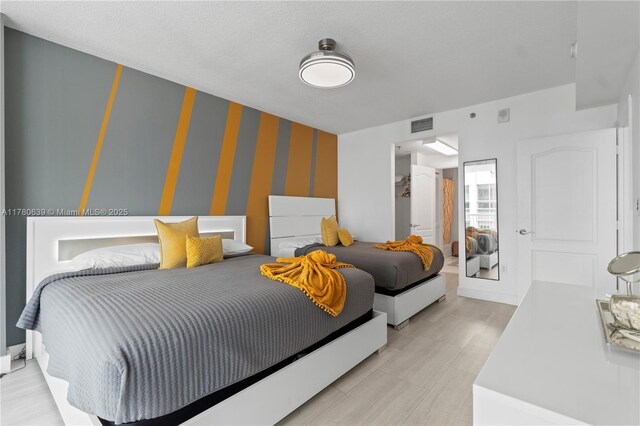 1200 Brickell Bay Dr Ph 4218, Miami, FL 33131 - bedroom featuring wallpapered walls and an accent wall