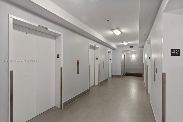 1200 Brickell Bay Dr Ph 4218, Miami, FL 33131 - hall featuring elevator and baseboards