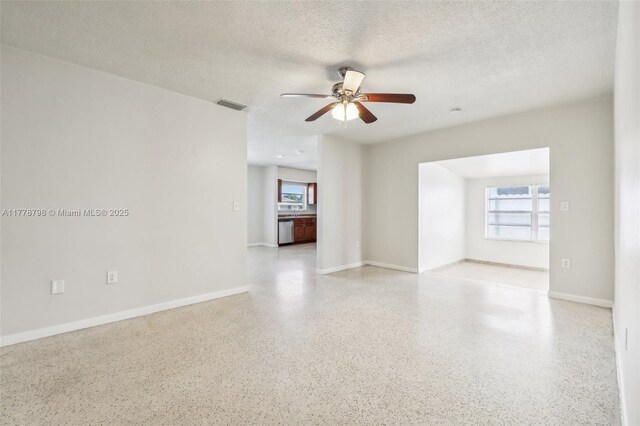 2650 SW 76th Ave, Miami, FL 33155 - spare room with dark aggregate flooring, ceiling fan, and a textured ceiling