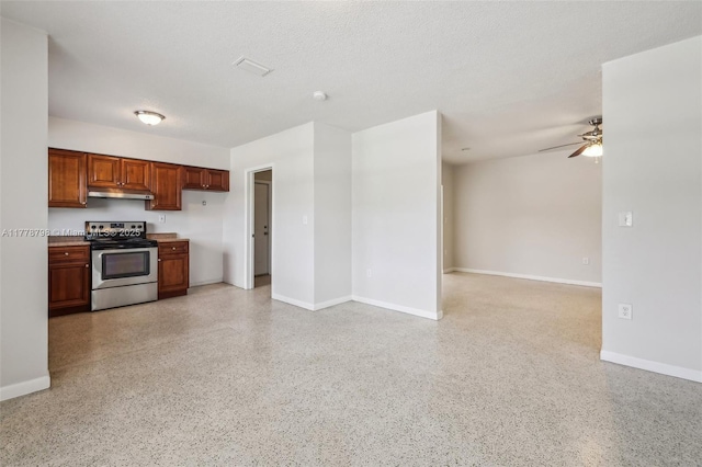 2650 SW 76th Ave, Miami, FL 33155 - kitchen with stainless steel range with electric cooktop, under cabinet range hood, dark aggregate flooring, a ceiling fan, and open floor plan