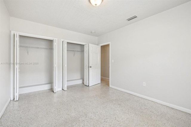 2650 SW 76th Ave, Miami, FL 33155 - unfurnished bedroom with multiple closets and speckle patterned floor