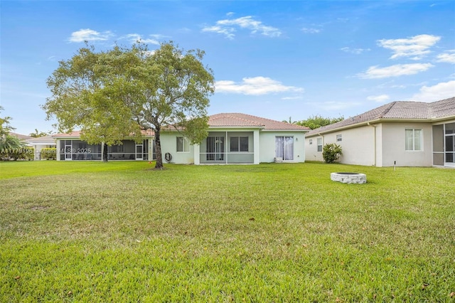 2821 Augusta Dr, Homestead, FL 33035 - back of property featuring a yard, stucco siding, a tiled roof, and a sunroom