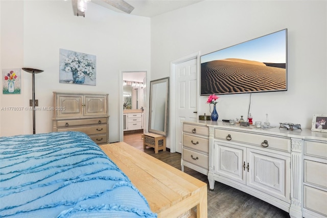 bedroom featuring ensuite bath, a high ceiling, and wood finished floors