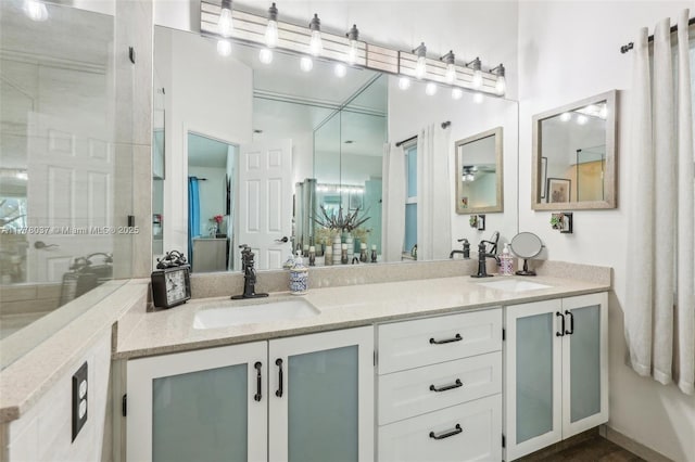 full bathroom with a sink and double vanity