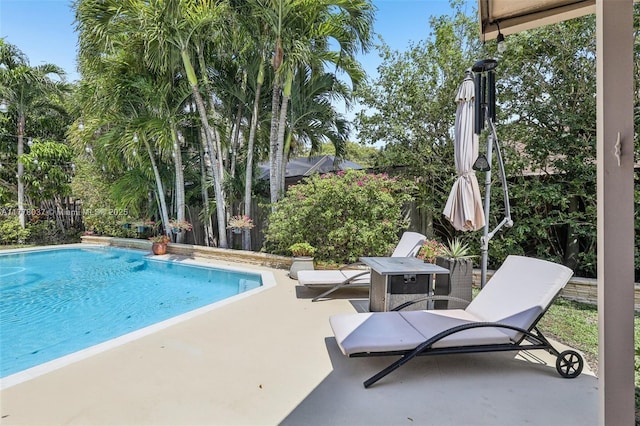 pool featuring a patio and fence