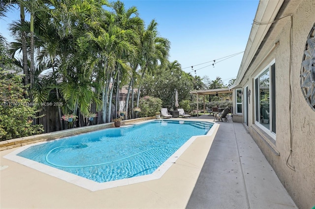 view of pool with a patio area, fence, and a fenced in pool