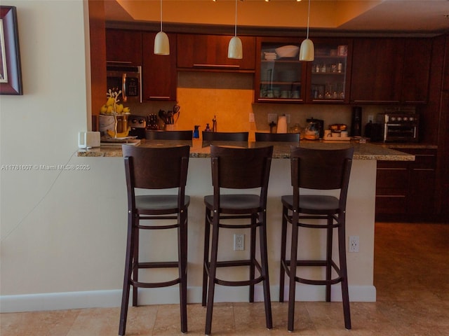 50 Ocean Lane Dr Unit 101, Key Biscayne, FL 33149 - bar with stainless steel microwave, pendant lighting, and indoor wet bar