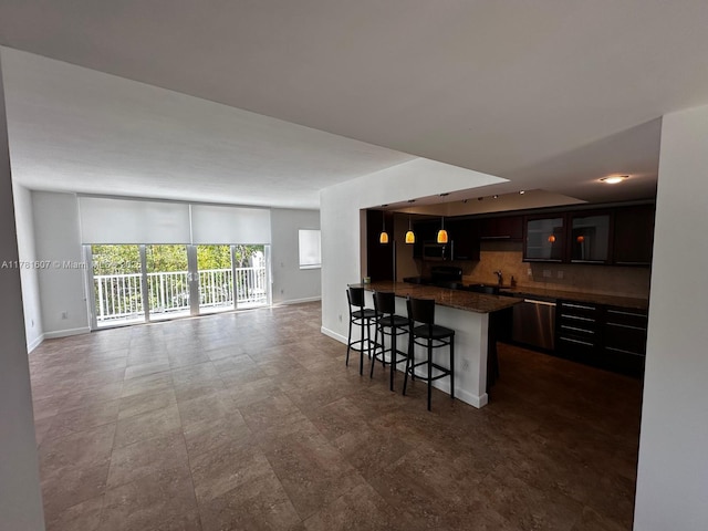 50 Ocean Lane Dr Unit 101, Key Biscayne, FL 33149 - kitchen with stainless steel dishwasher, baseboards, a kitchen bar, and open floor plan