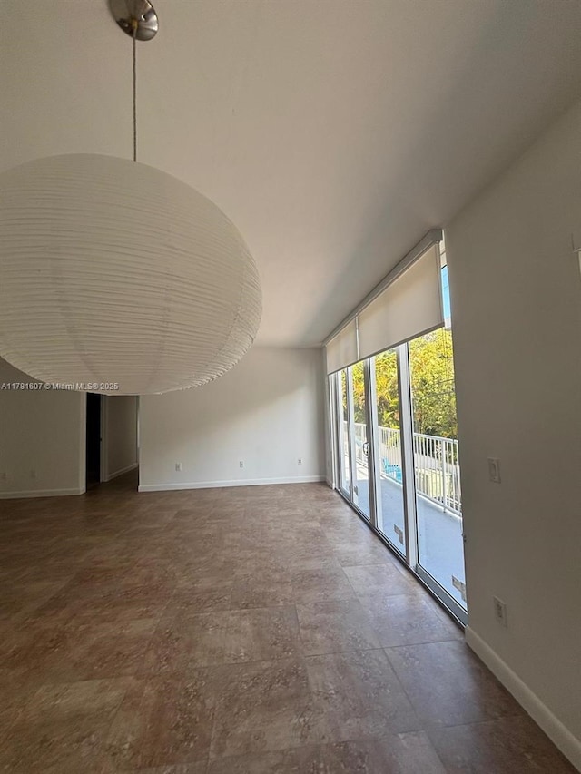50 Ocean Lane Dr Unit 101, Key Biscayne, FL 33149 - unfurnished living room featuring baseboards and lofted ceiling