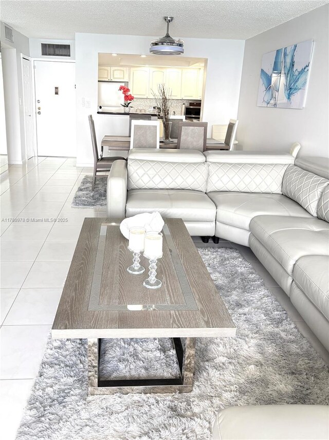 2101 S Ocean Dr Unit 1902, Hollywood, FL 33019 - living area featuring light tile patterned flooring, a textured ceiling, and visible vents
