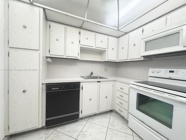 3800 S Ocean Dr Unit 1114, Hollywood, FL 33019 - kitchen featuring white appliances, light marble finish flooring, light countertops, and white cabinets