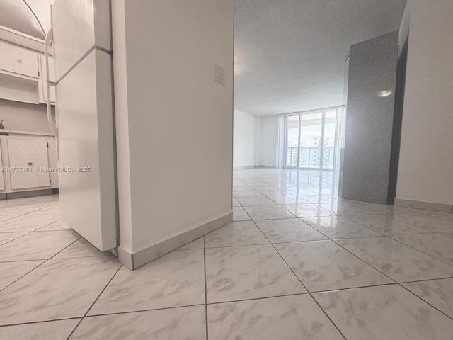 3800 S Ocean Dr Unit 1114, Hollywood, FL 33019 - corridor with baseboards and a wall of windows