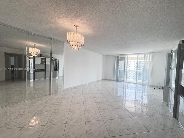 3800 S Ocean Dr Unit 1114, Hollywood, FL 33019 - tiled empty room with a chandelier, floor to ceiling windows, and a textured ceiling