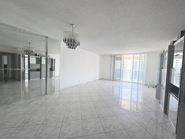 3800 S Ocean Dr Unit 1114, Hollywood, FL 33019 - tiled spare room with a chandelier, floor to ceiling windows, and a textured ceiling