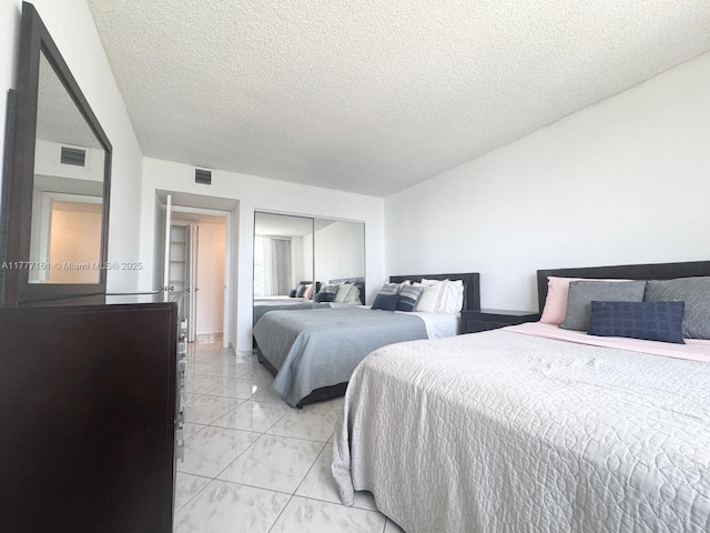 3800 S Ocean Dr Unit 1114, Hollywood, FL 33019 - bedroom with light marble finish flooring, a closet, and a textured ceiling