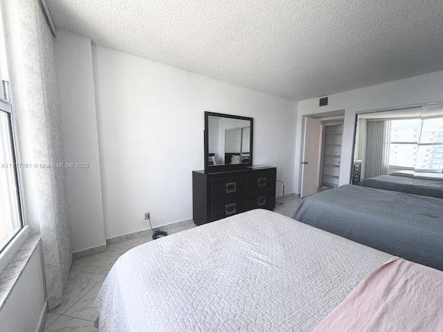 3800 S Ocean Dr Unit 1114, Hollywood, FL 33019 - bedroom with a textured ceiling and light marble finish floors