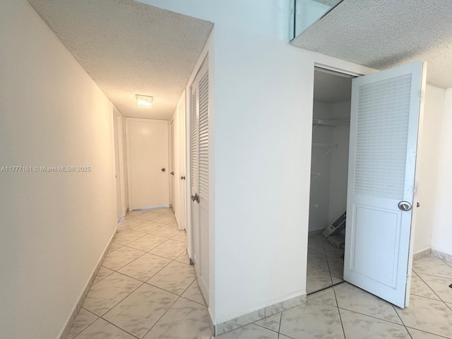 3800 S Ocean Dr Unit 1114, Hollywood, FL 33019 - corridor featuring a textured ceiling and light marble finish floors
