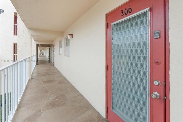 1020 Country Club Dr Unit 206, Margate, FL 33063 - view of exterior entry with a balcony and stucco siding