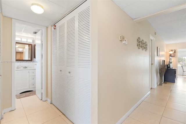 1020 Country Club Dr Unit 206, Margate, FL 33063 - hall featuring a sink, light tile patterned floors, and baseboards