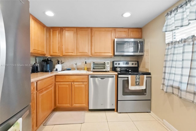 1020 Country Club Dr Unit 206, Margate, FL 33063 - kitchen with a sink, light countertops, appliances with stainless steel finishes, a toaster, and light tile patterned flooring