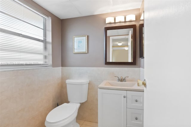 1020 Country Club Dr Unit 206, Margate, FL 33063 - half bathroom with toilet, vanity, wainscoting, and tile walls