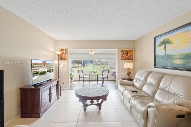 1020 Country Club Dr Unit 206, Margate, FL 33063 - living room featuring a textured ceiling, light tile patterned floors, and baseboards