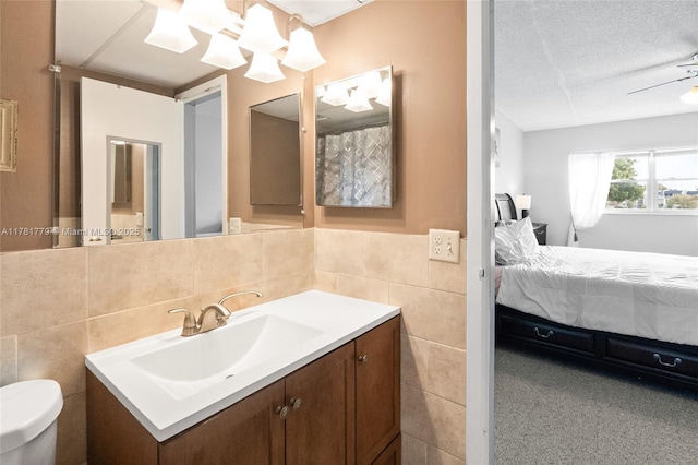 1020 Country Club Dr Unit 206, Margate, FL 33063 - ensuite bathroom featuring toilet, tile walls, a textured ceiling, vanity, and ensuite bath