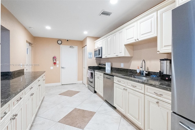 1020 Country Club Dr Unit 206, Margate, FL 33063 - kitchen with dark stone counters, visible vents, recessed lighting, appliances with stainless steel finishes, and a sink