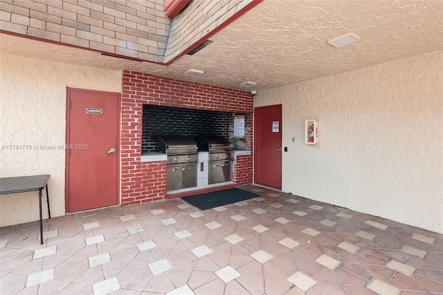 1020 Country Club Dr Unit 206, Margate, FL 33063 - doorway to property with exterior kitchen, a patio area, brick siding, and stucco siding