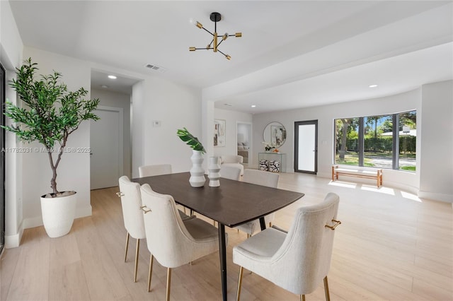 dining area with light wood-style floors, an inviting chandelier, visible vents, and recessed lighting