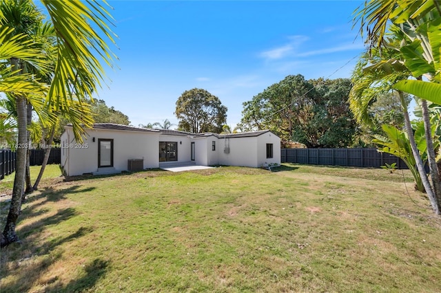 exterior space with central AC unit, fence, and a patio