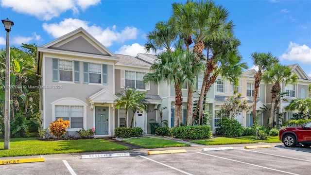 8066 Sanibel Dr Unit 8066, Tamarac, FL 33321 - view of front of property featuring a front yard, uncovered parking, and stucco siding