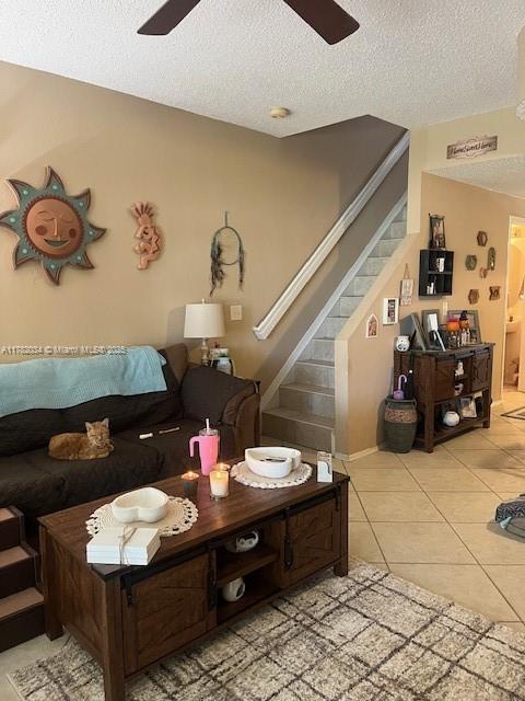 8066 Sanibel Dr Unit 8066, Tamarac, FL 33321 - living area with a textured ceiling, ceiling fan, light tile patterned floors, and stairway