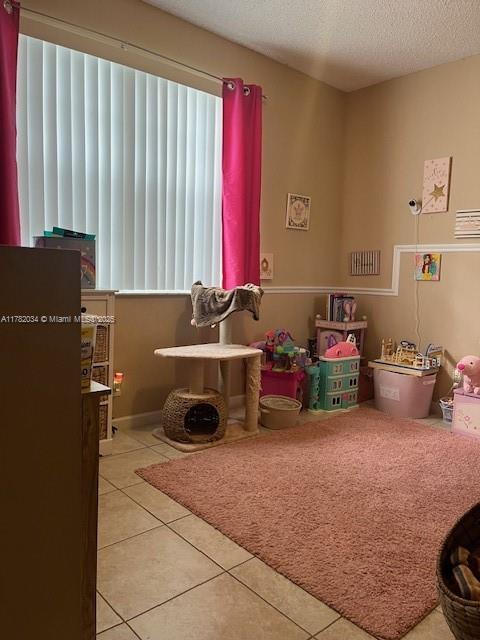 8066 Sanibel Dr Unit 8066, Tamarac, FL 33321 - rec room with a textured ceiling and tile patterned flooring