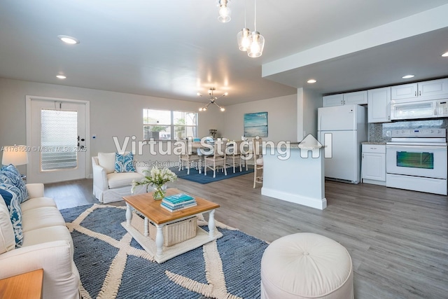 494 Monaco K Unit 494, Delray Beach, FL 33446 - living room featuring a chandelier, recessed lighting, baseboards, and wood finished floors