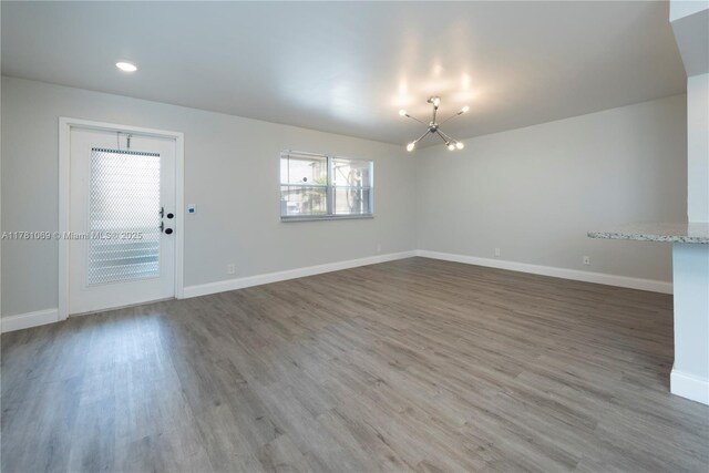 494 Monaco K Unit 494, Delray Beach, FL 33446 - unfurnished room with baseboards, a chandelier, and wood finished floors