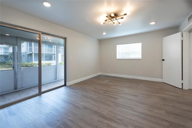 494 Monaco K Unit 494, Delray Beach, FL 33446 - spare room featuring a chandelier, wood finished floors, baseboards, and recessed lighting