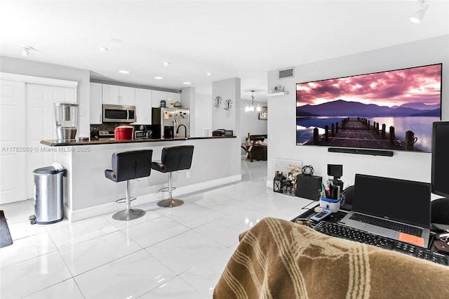 living area with marble finish floor, baseboards, visible vents, and recessed lighting
