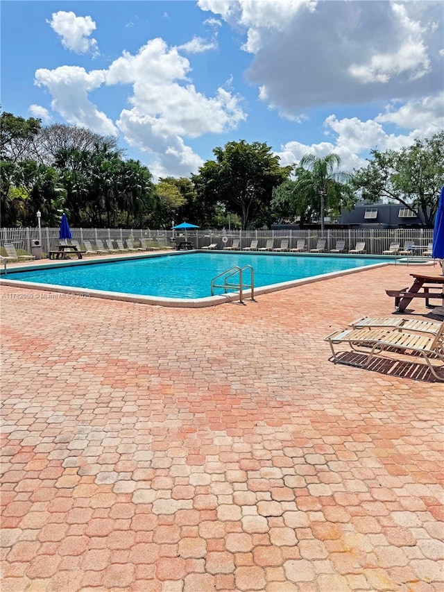 pool featuring a patio area and fence