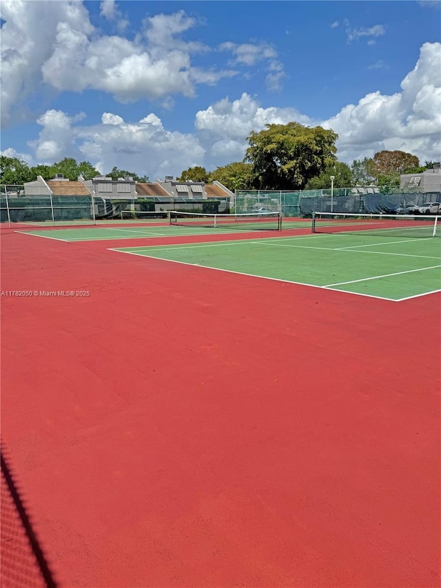 view of sport court featuring fence