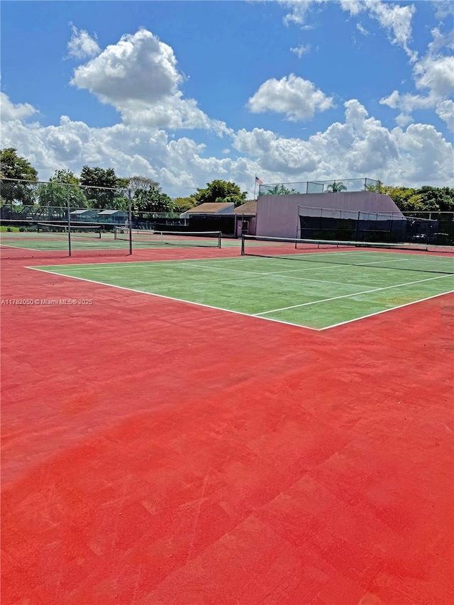 view of tennis court with fence