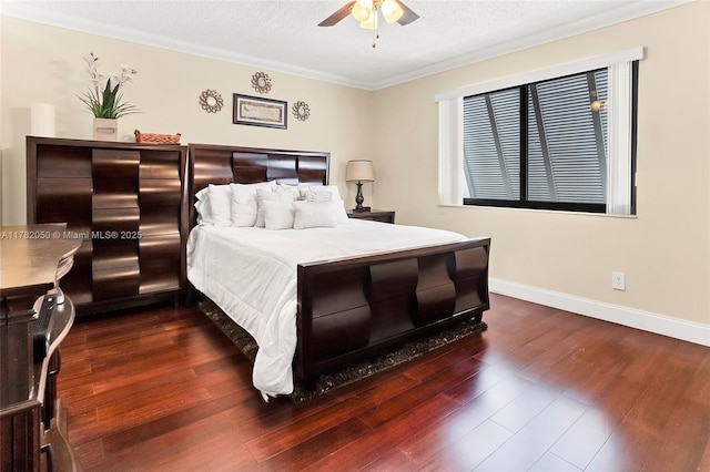 bedroom with crown molding, dark wood finished floors, a textured ceiling, a ceiling fan, and baseboards