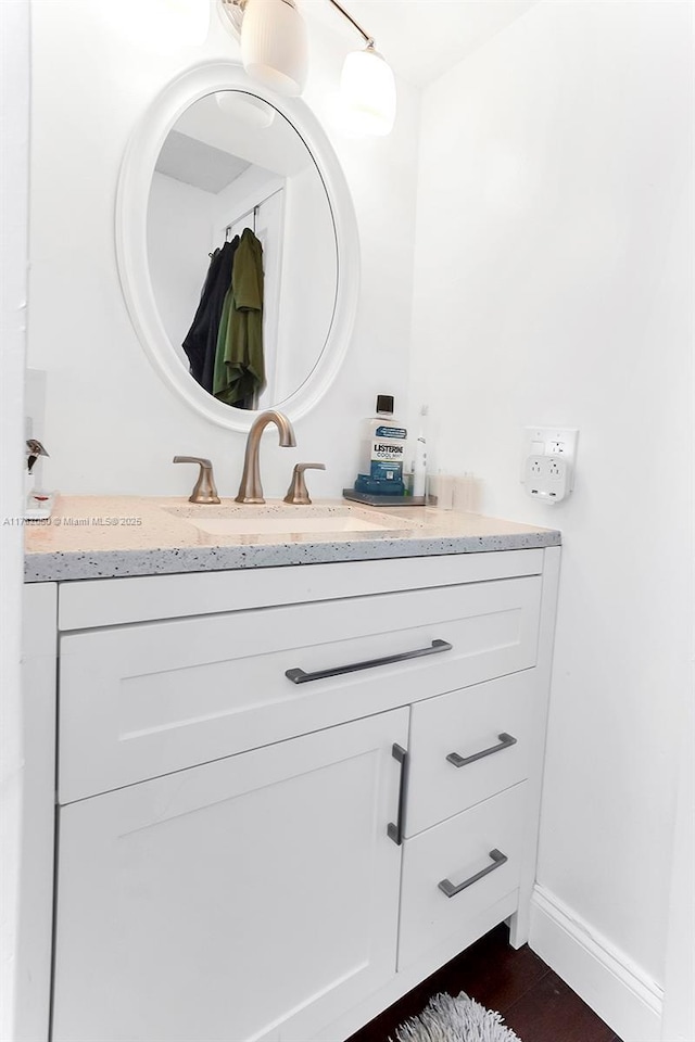 bathroom with vanity and baseboards