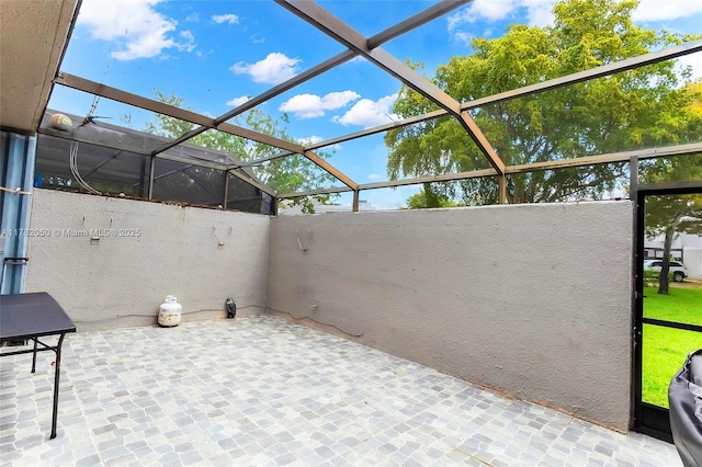 view of patio / terrace featuring glass enclosure