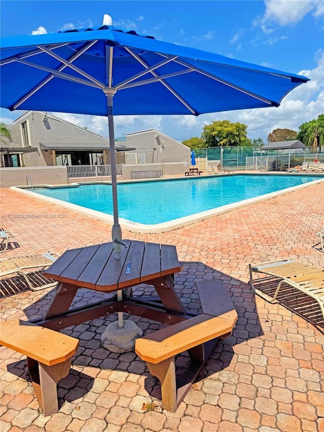 pool featuring a patio area and fence
