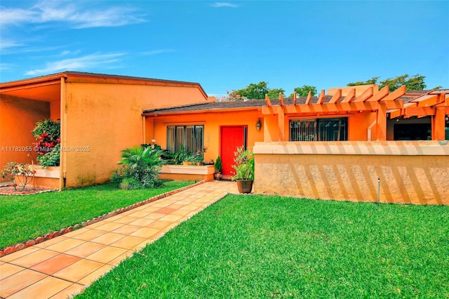 861 NW 79th Ter, Plantation, FL 33324 - back of house with a pergola, stucco siding, and a lawn